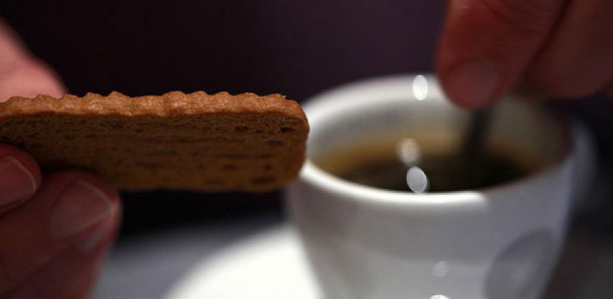 Dunking a cookie into a cup of coffee
