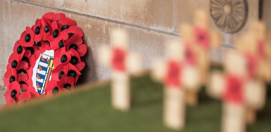 Close-up of a poppy wreath on a war memorial