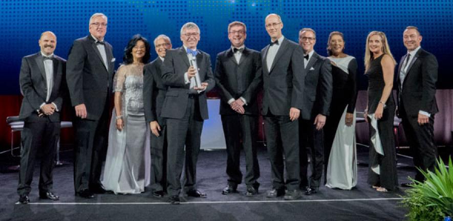 Collecting the Boeing Innovation Award on behalf of the University of Cambridge: Professor Bill O'Neill (holding the Award), Dr John Durrell (centre), and Philip Guildford (centre, right).