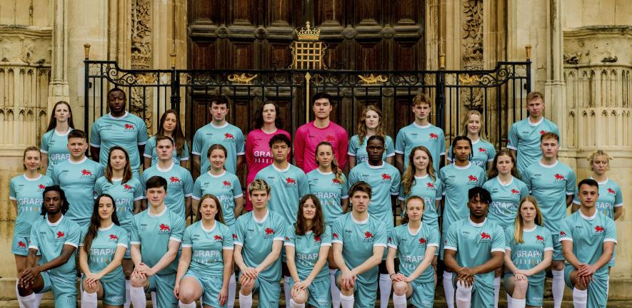 A group of student footballers wearing University of Cambridge kit