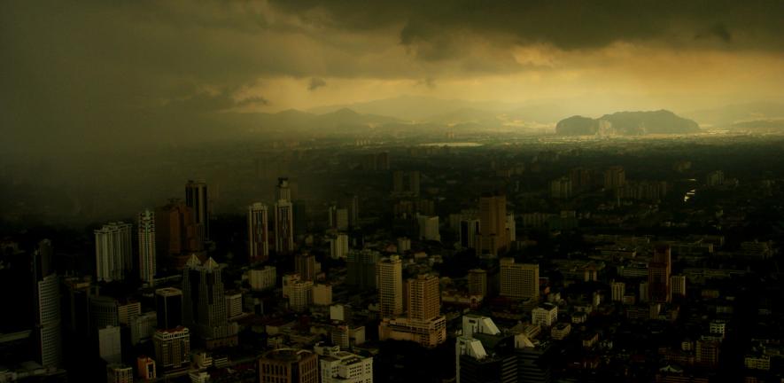 A dark skyline above a polluted cityscape