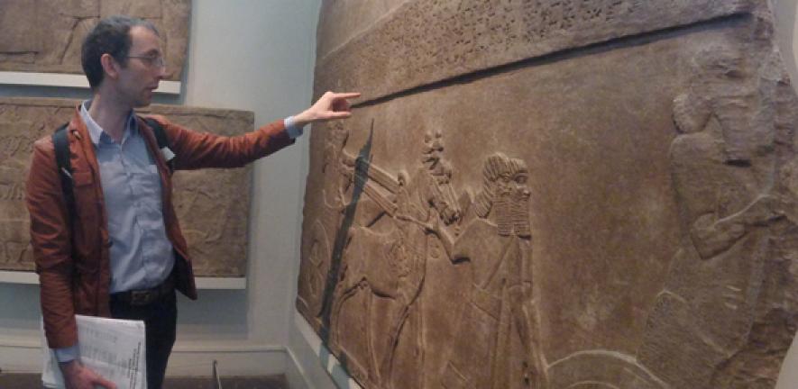 Dr Martin Worthington reads a Neo-Assyrian royal inscription in the British Museum