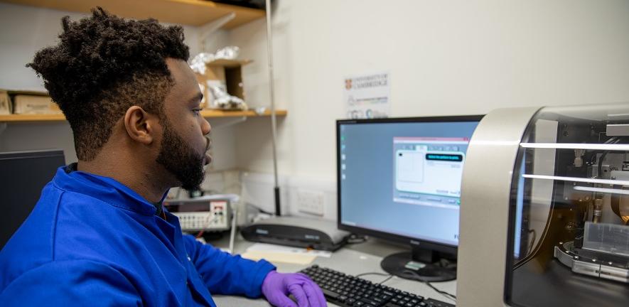 Postgraduate student looking at experiment results on screen