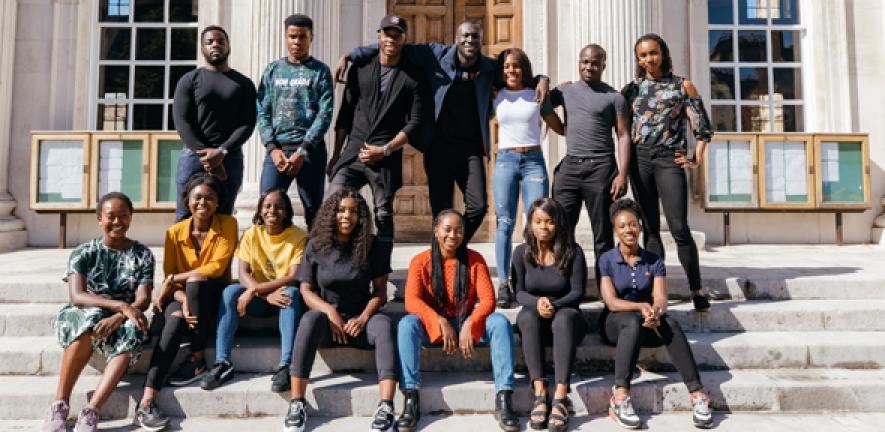 Stormzy with Cambridge students on the steps of Senate House at the University
