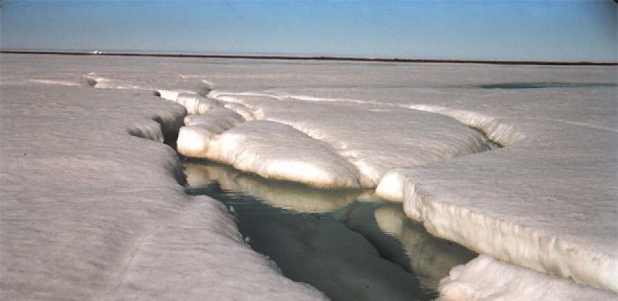 The first sign of the spring melt - a stream is seen flowing on the ice in the Arctic.