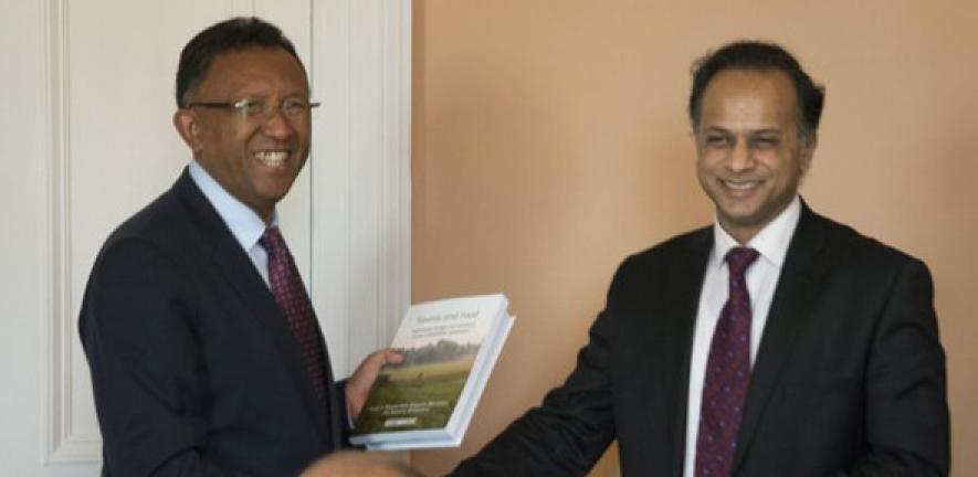 The President of the Republic of Madagascar, Hery Rajaonarimampianina, receiving a copy of Forests and Food during his recent visit to Cambridge