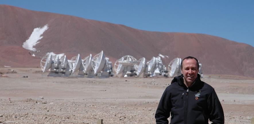 John, in front of the 12-metre-diameter antennas at the ALMA Array Operations Site