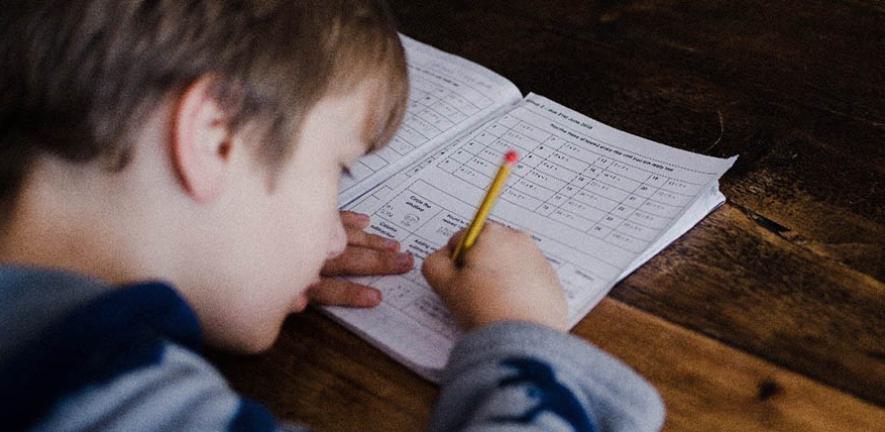 Young boy completes homework