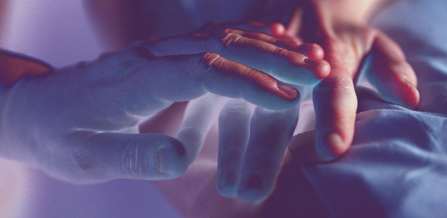 Experimental coloured image of two hands touching