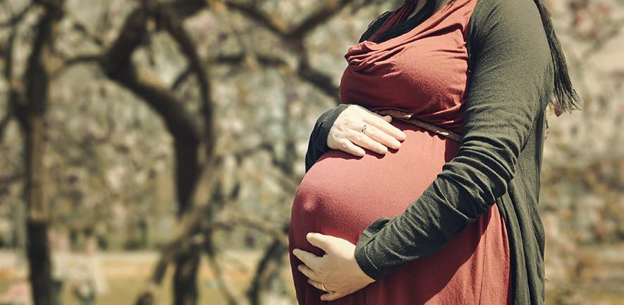 Pregnant woman holding her stomach