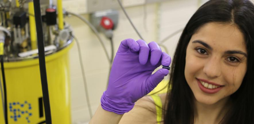 PhD student Maria Kiourlappou holding a piece of SmB6