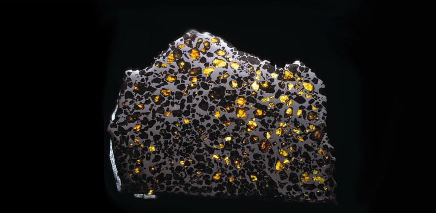 The Esquel pallasite from the Natural History Museum collections, consists of gem-quality crystals of the silicate mineral olivine embedded in a matrix of iron-nickel alloy.