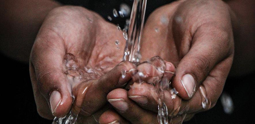 Pouring water on person's hands