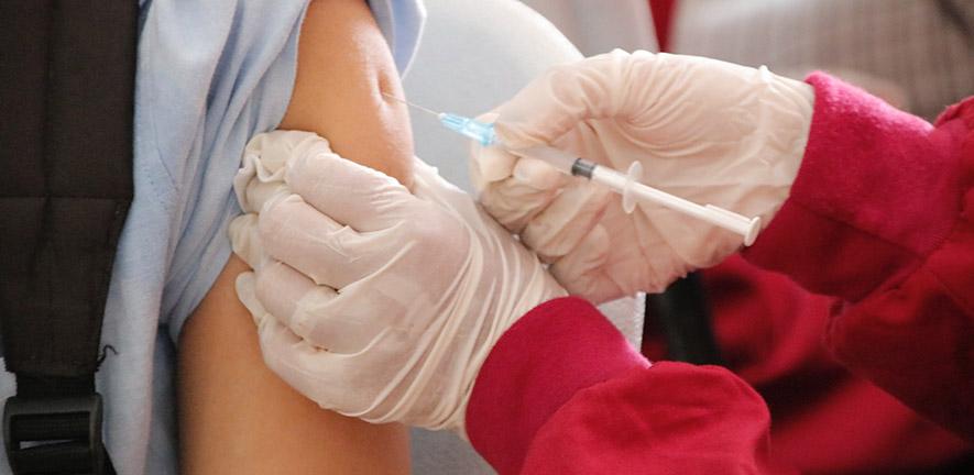 Close up of a person being injected with a vaccine