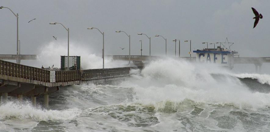 El Niño waves crash into a pier