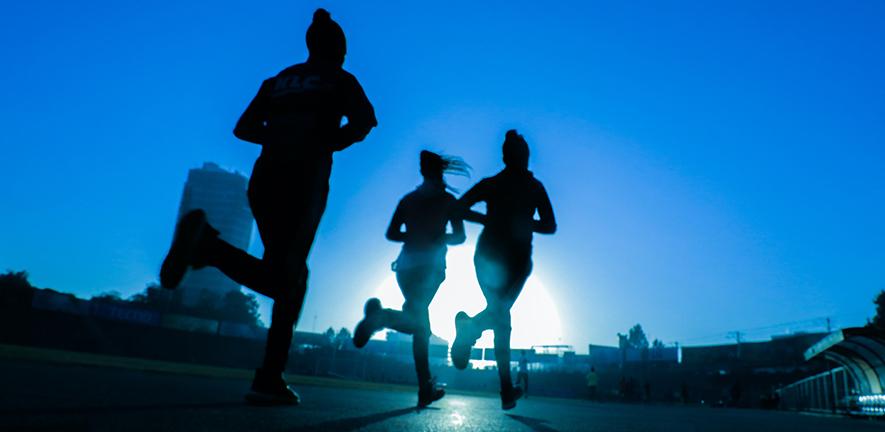 Silhouettes of three women running