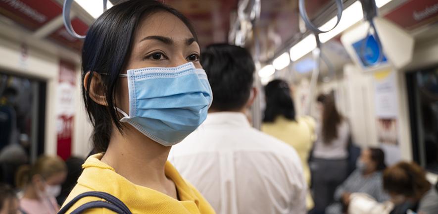 Woman wearing a mask on public transport