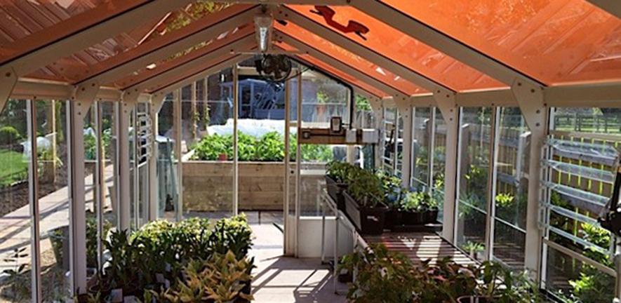 Greenhouse with tinted solar panels