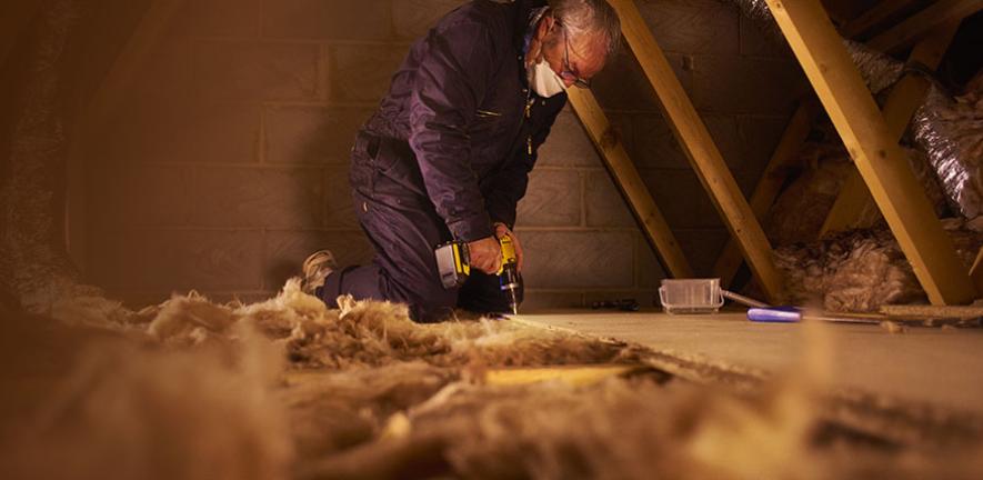 Man installing loft insulation