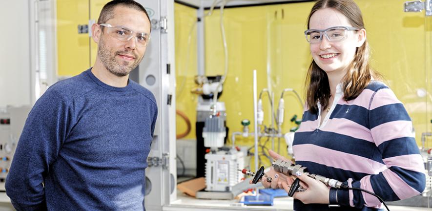 Two smiling scientists in a lab