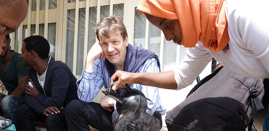 James Wood enjoying amazing freshly roasted Ethiopian coffee in a traditional coffee house in Sebeta, during a field trip prior to the COVID-19 pandemic