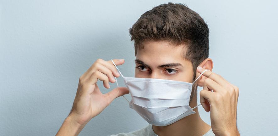 Man putting on a facemask