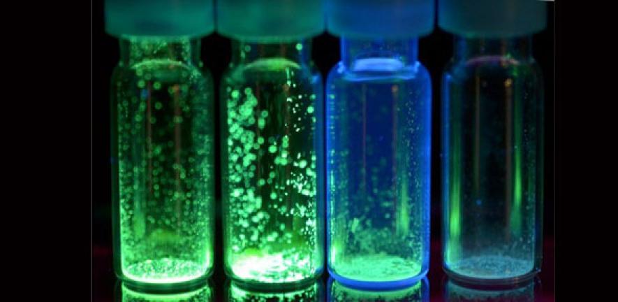 Molecules in a test tube giving off light 