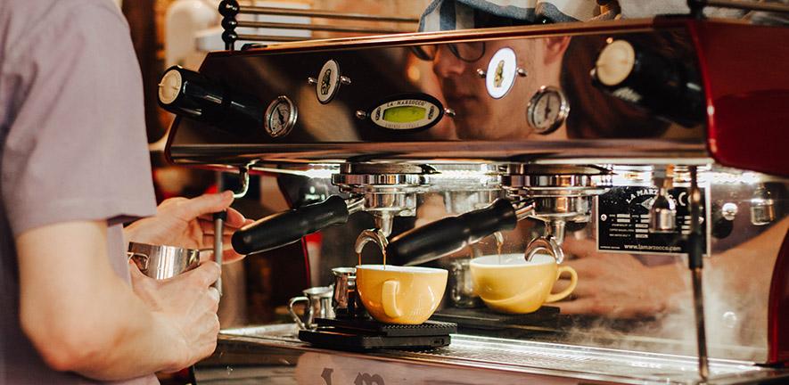 Person using an espresso machine