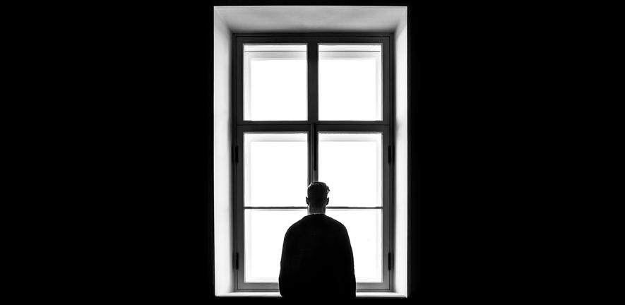 Man standing in front of window