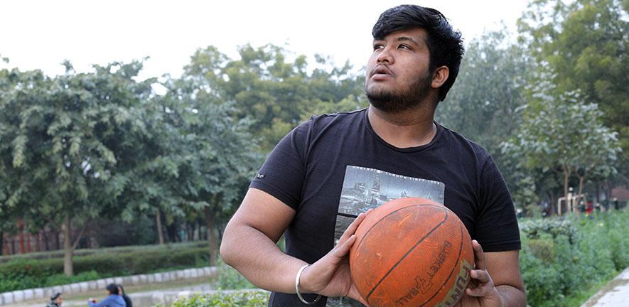 Overweight man playing basketball