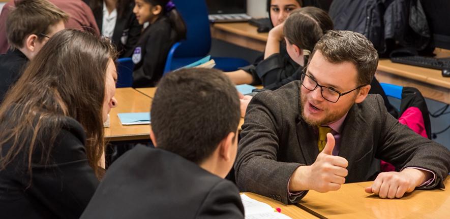Teacher speaking with students