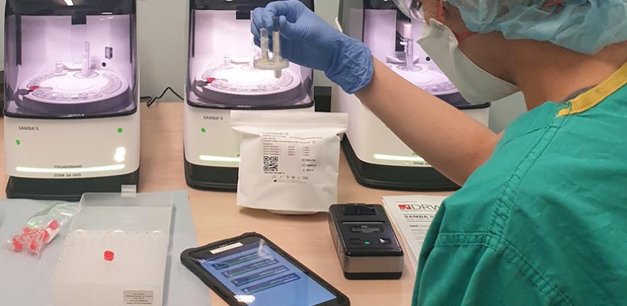 Research nurse from the NIHR Clinical Research Facility processing patient samples using SAMBA machines at Adden brooke’s Hospital in Cambridge