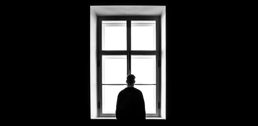 Man standing in front of window