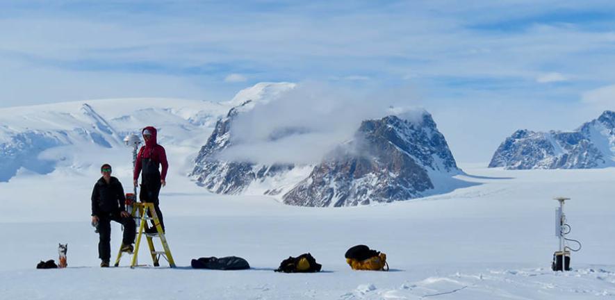 Ali Banwell and Laura Stevens installing the time-lapse camera used in this study on the George VI Ice Shelf in Antarctica. 