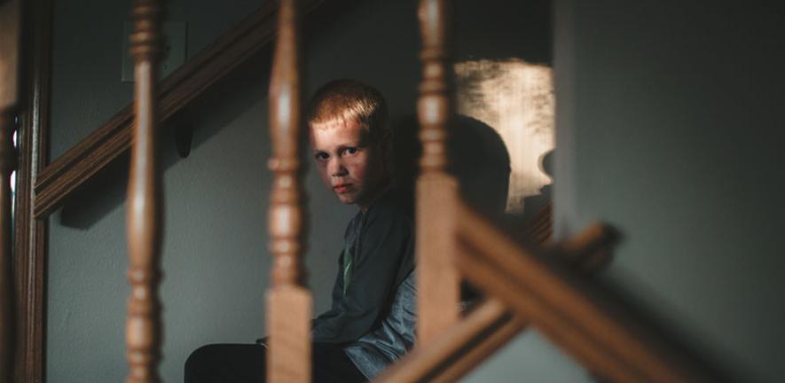 Angry boy on stairs 