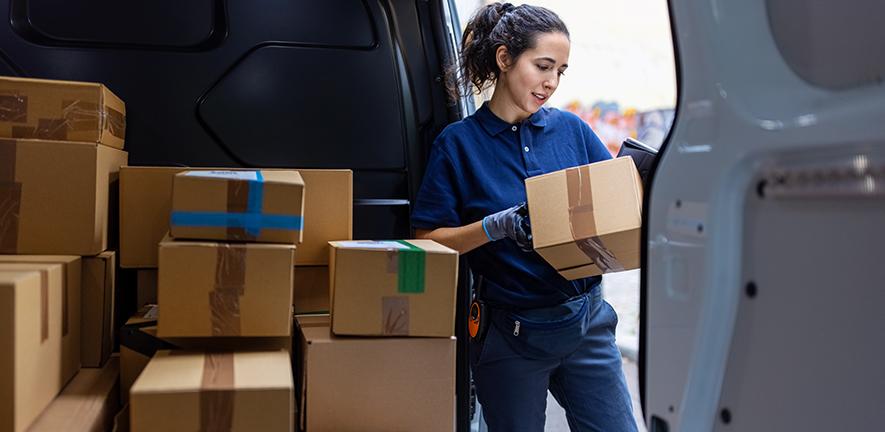 Courier checking parcel for delivery