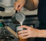A barista making a coffee