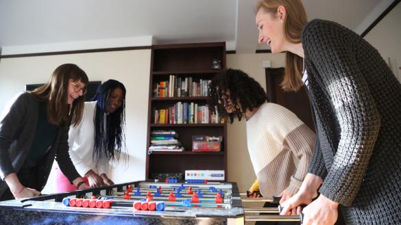 Four students playing table football