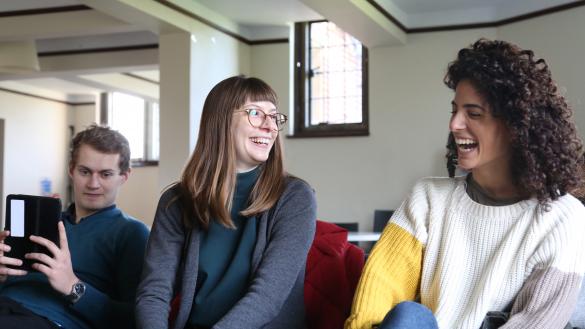 Three students chatting and laughing