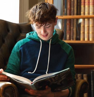 Student reading book in library.