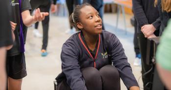 Student using an indoor rowing machine