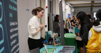 Cambridge stall is staffed by one person at Green Careers Fair talking to students