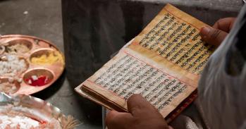 Priest reading Hindu scripts