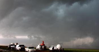 Vehicles with weather observation equipment track a storm