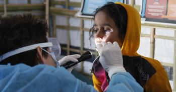 UK Emergency Medical Team paediatric nurse checks a girl for symptoms of Diphtheria in the Kutapalong refugee camp, Bangladesh