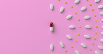 Pills and a capsule on pastel pink colored background. 3D rendered image.