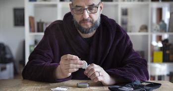 Man using blood sugar measurement device to monitor diabetes - stock photo