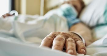 Senior woman wearing face mask lying on hospital bed