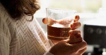 Woman holding a glass of whisky