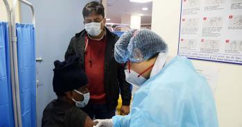 Health care workers administering covid-19 vaccination in New Delhi